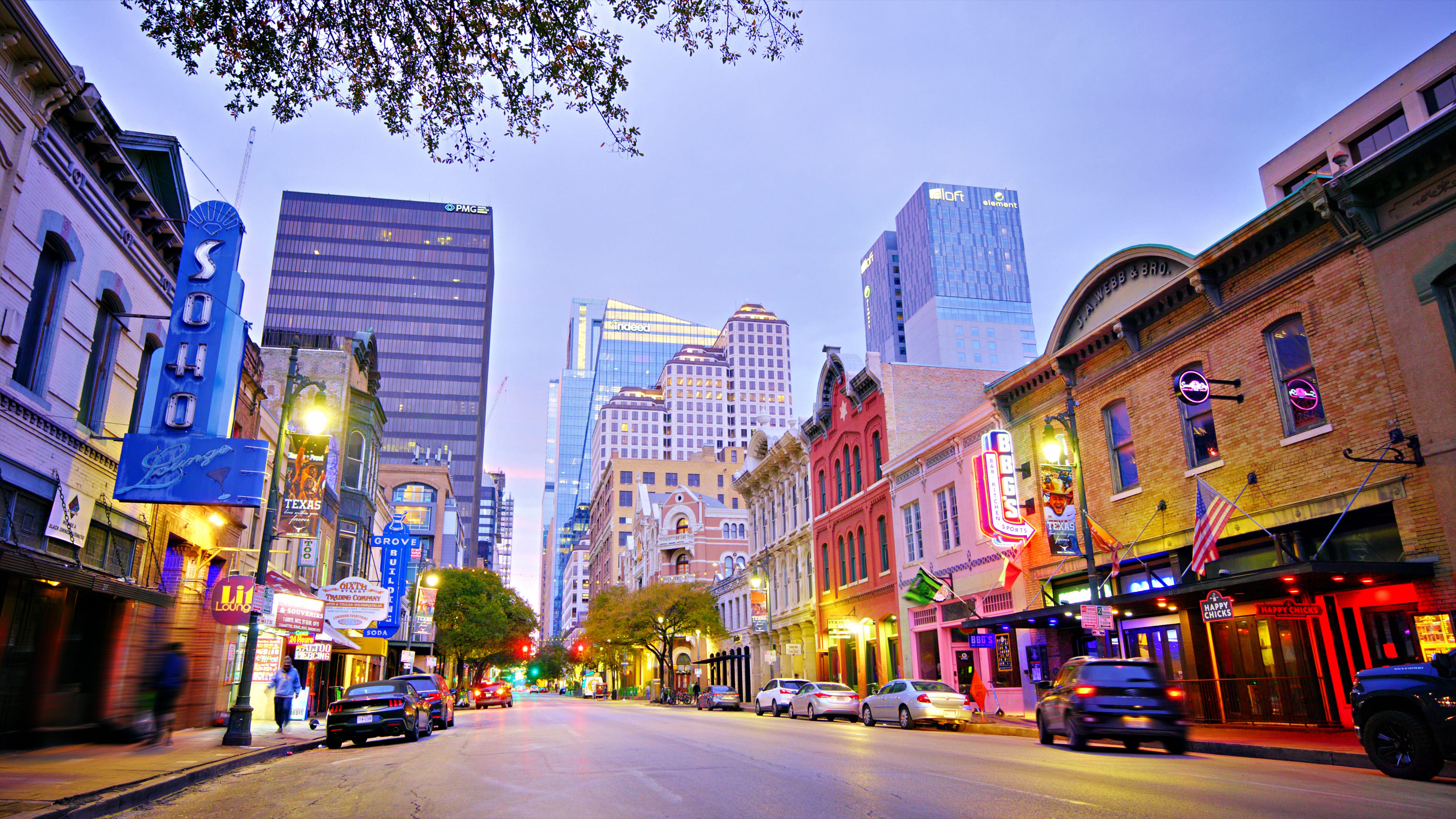 A street in downtown Austin with cars parked.