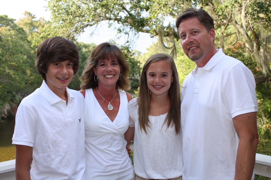 Christina Daves and her family all wearing white
