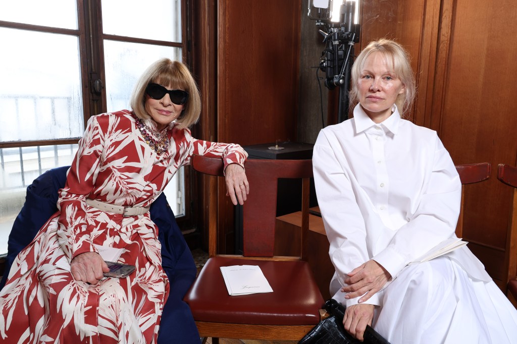 Anna Wintour in sunglasses, in a red and white pattered dress, Pamela Anderson in a white shirt dress.