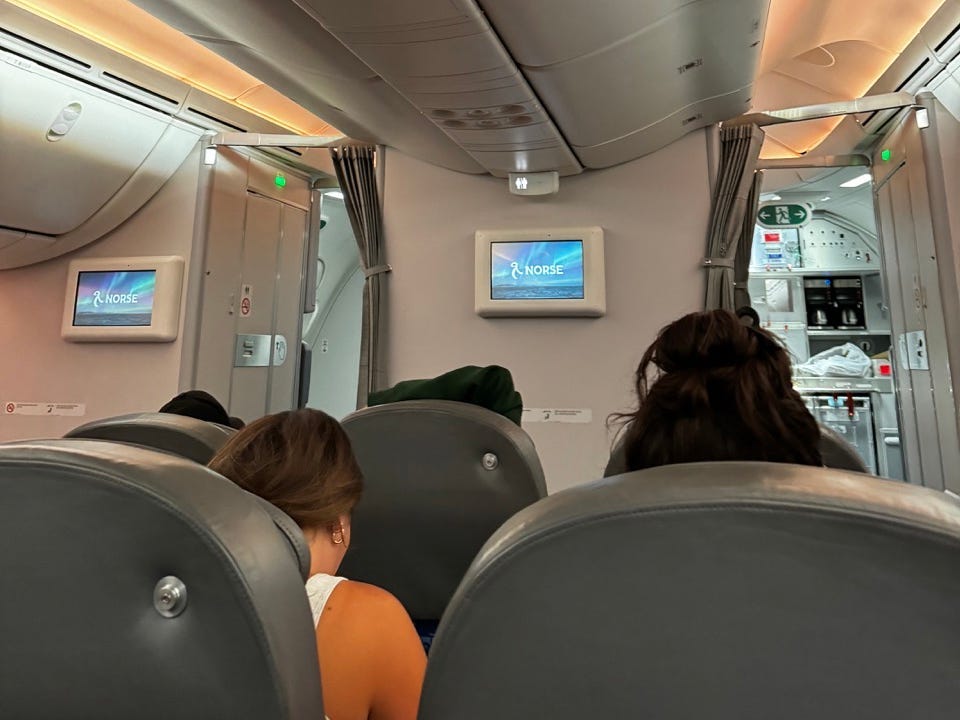 View of seatbacks in premium cabin on Norse Airways flight, two seats per row