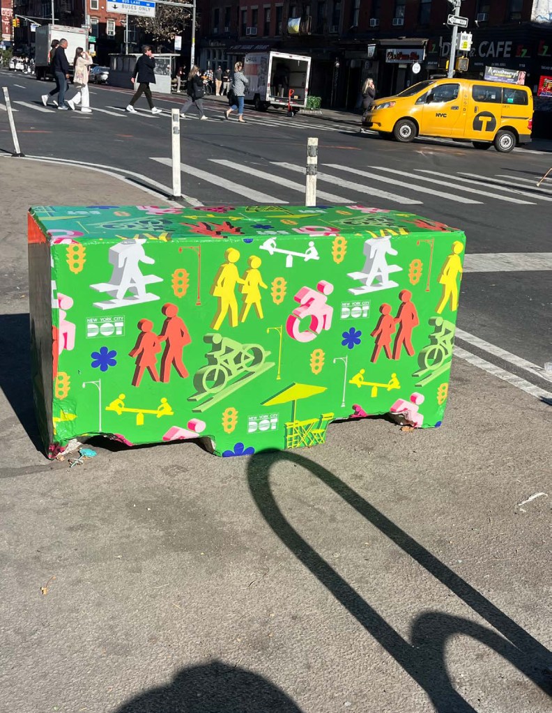 Daylighting traffic barrier with pedestrian and cyclist illustrations.