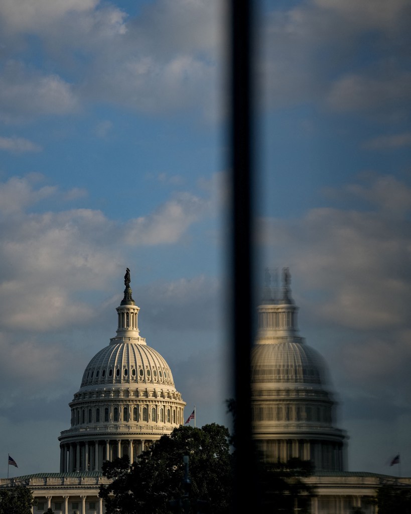 The US Capitol dome reflected in a window.