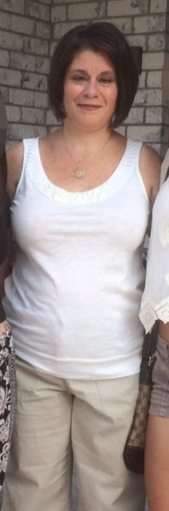 michelle cenci in white tank top and khakis smiling at camera