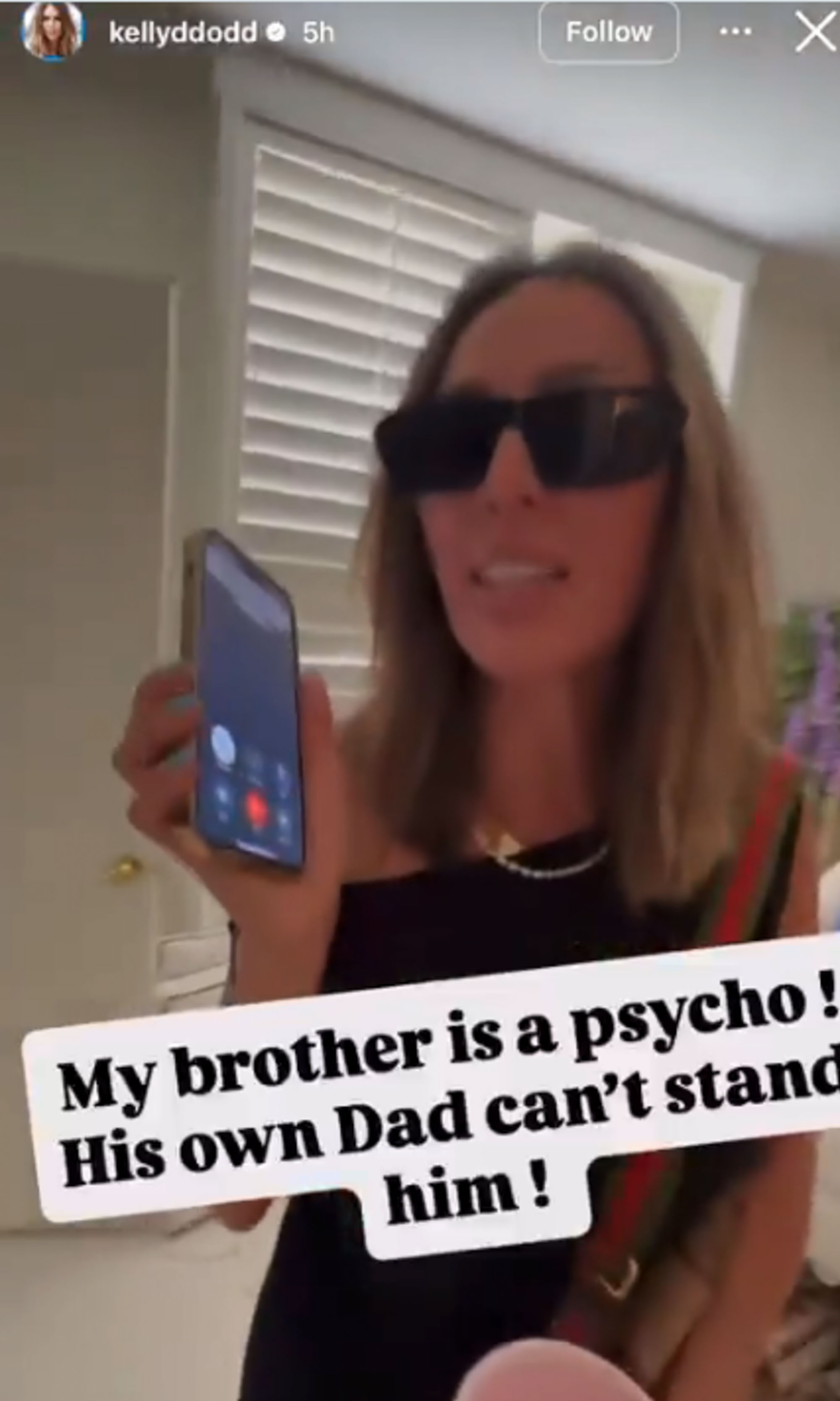Kelly Dodd talks to a phone. 