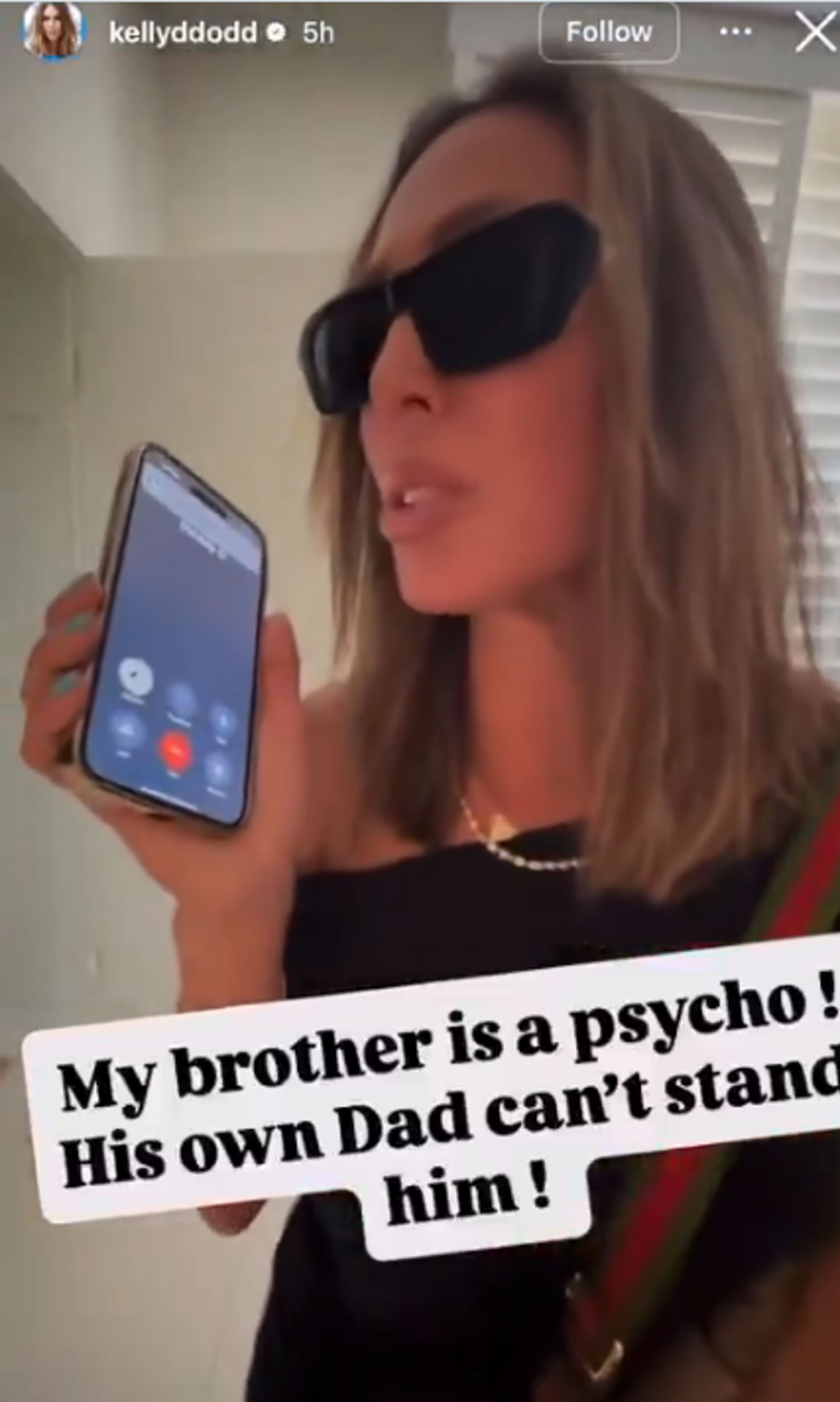 Kelly Dodd on the phone in sunglasses. 