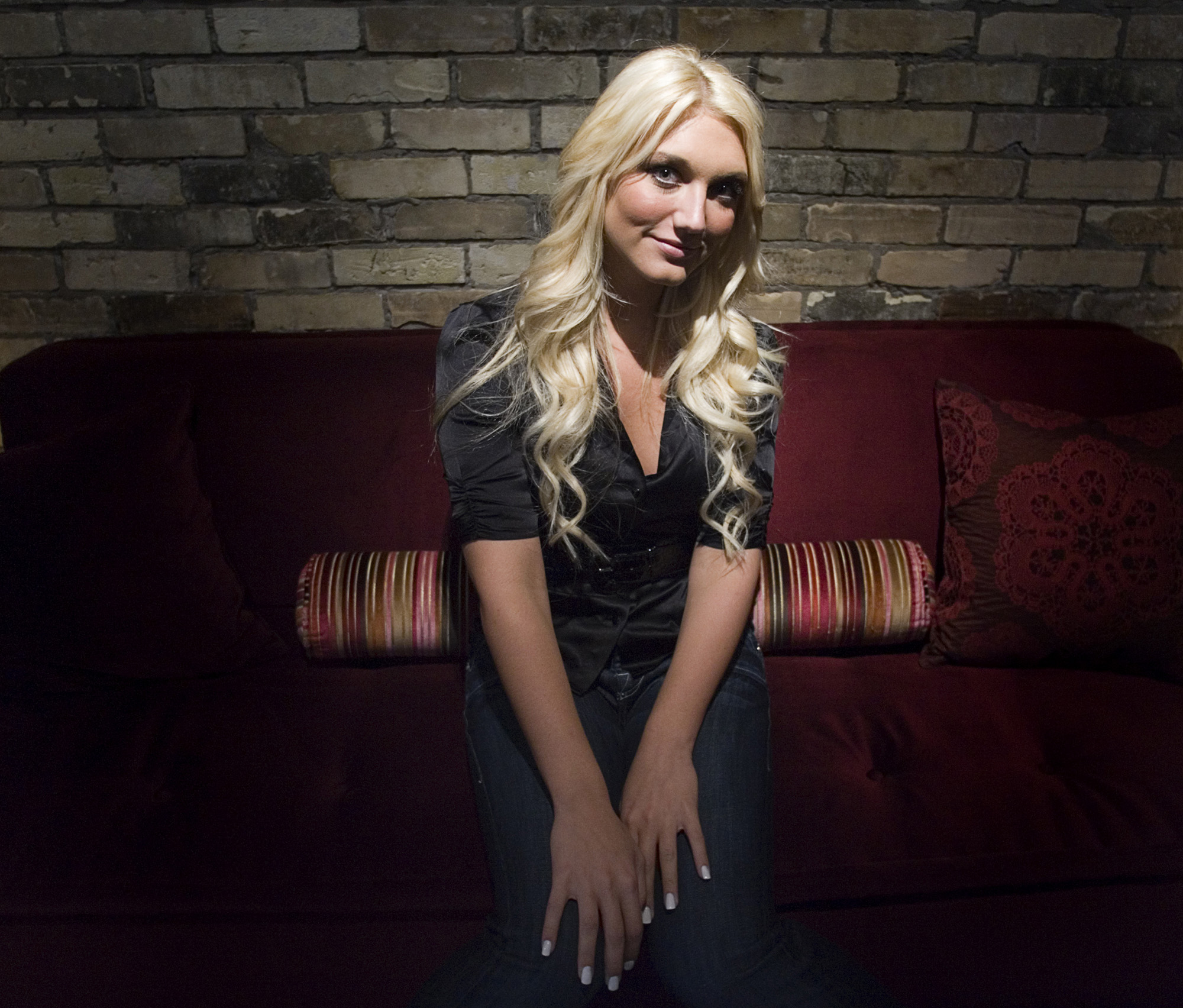 Brooke Hogan in a dimly lit location. 