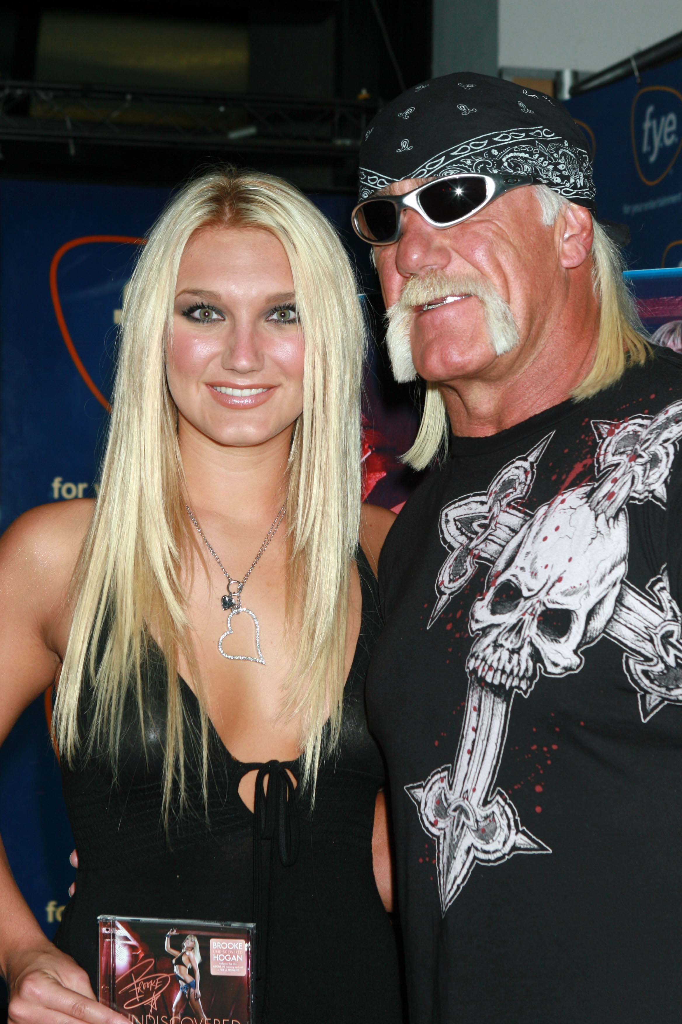 Hulk Hogan and Brooke Hogan pose for a photo. 