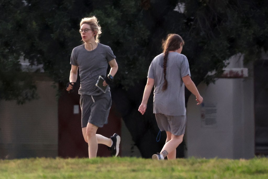 Elizabeth Holmes jogging outdoors.