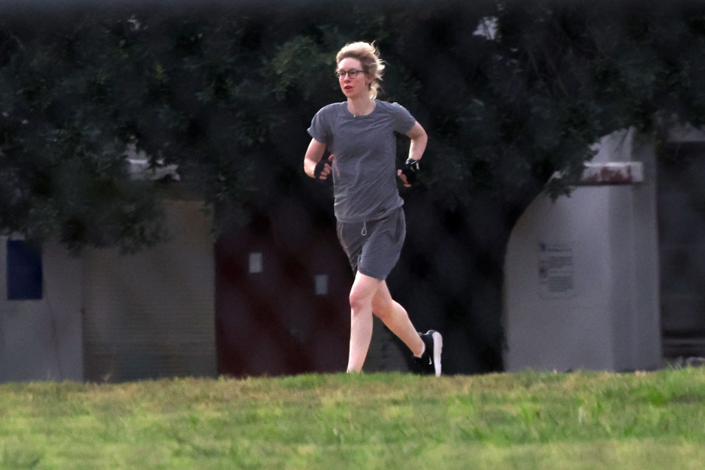 Elizabeth Holmes jogging outdoors.