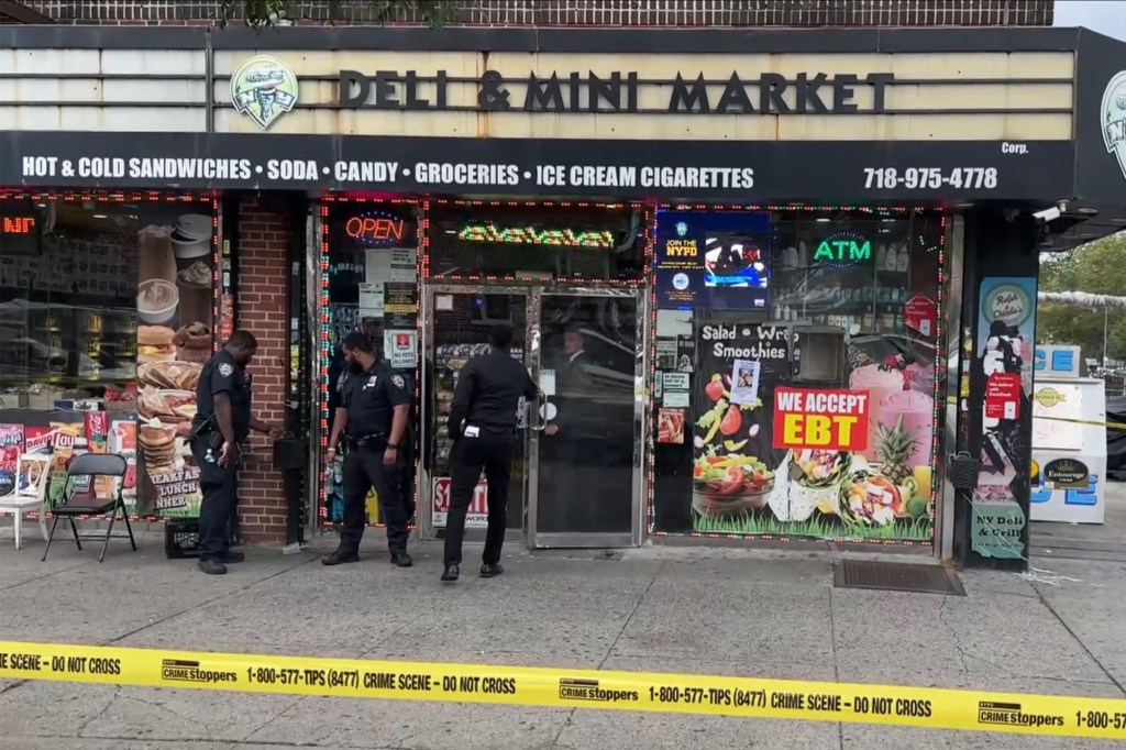 Police officers at a deli crime scene.