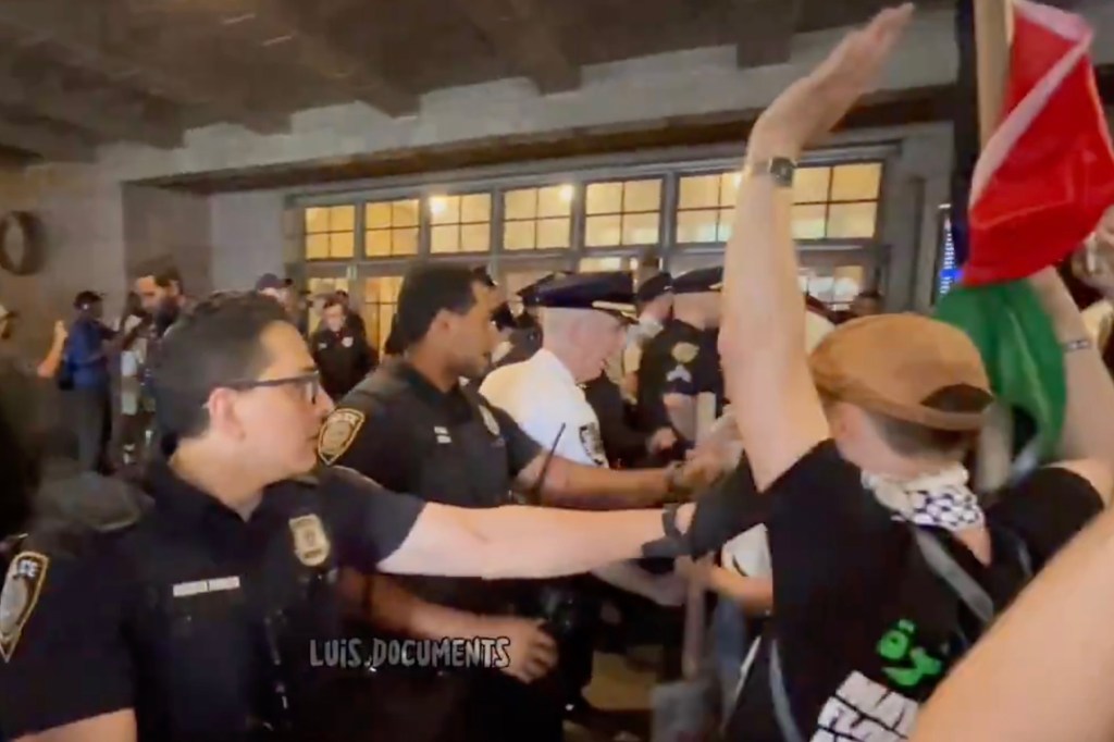 NYPD officers detaining Palestine protestors at Grand Central Terminal.