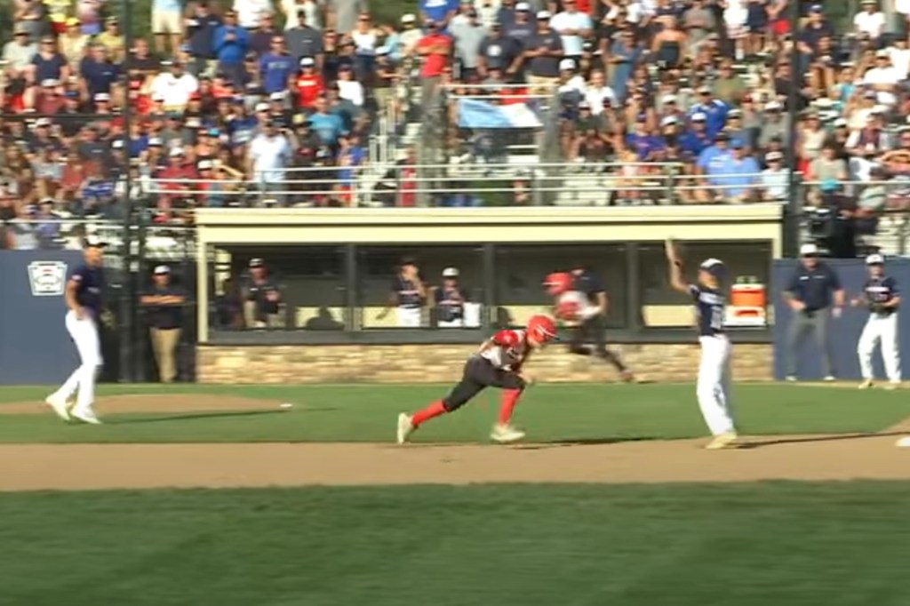 Baseball player running bases.