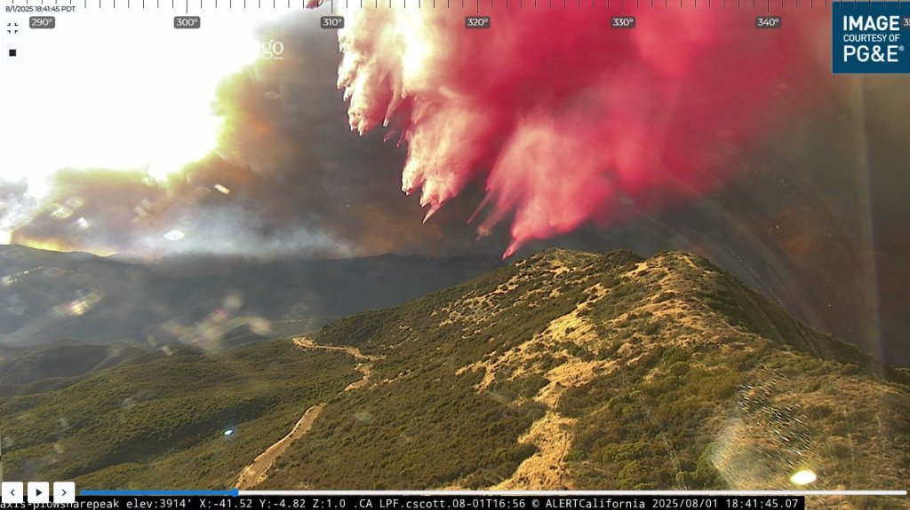 Aerial view of a wildfire being fought with fire retardant.