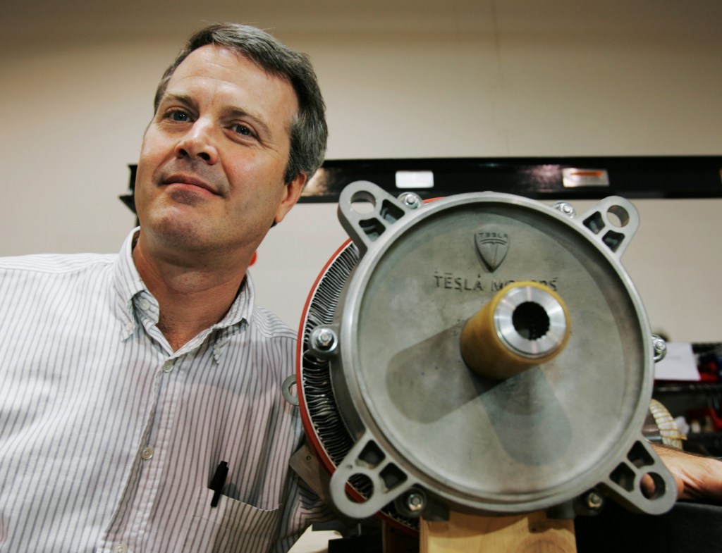 Martin Eberhard, Tesla co-founder, posing with a Tesla Motors electric motor.