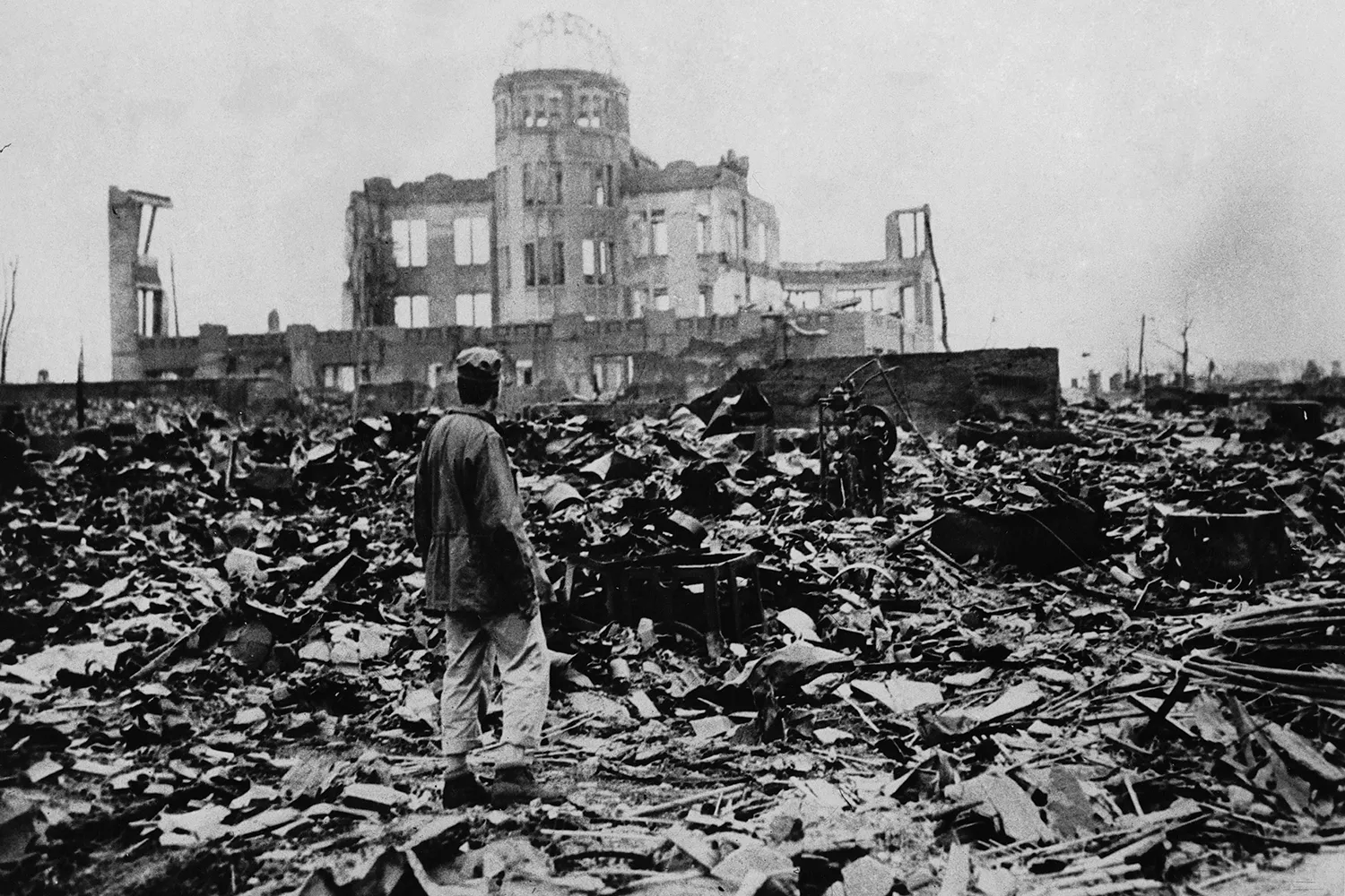 A man stands amid the ruins of Hiroshima, Japan, after the United States dropped an atomic bomb on Aug. 6, 1945. The shell of the Genbaku Dome is the only building left standing.