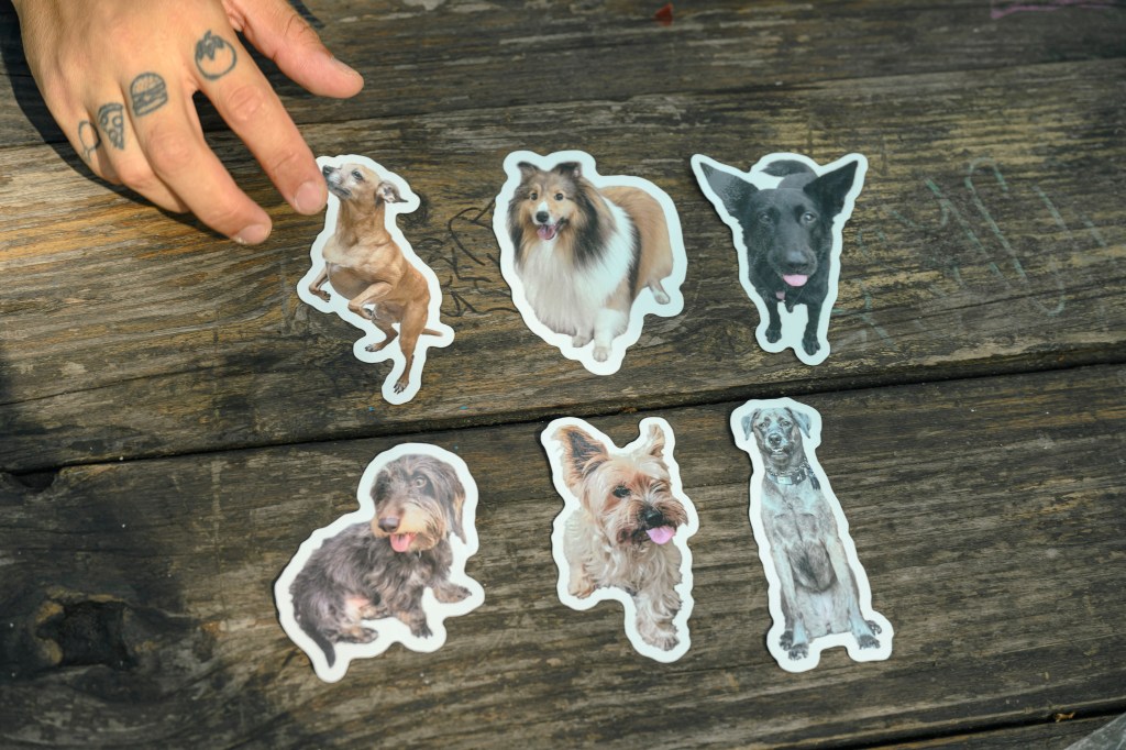 Nick lays his stickers on a table.