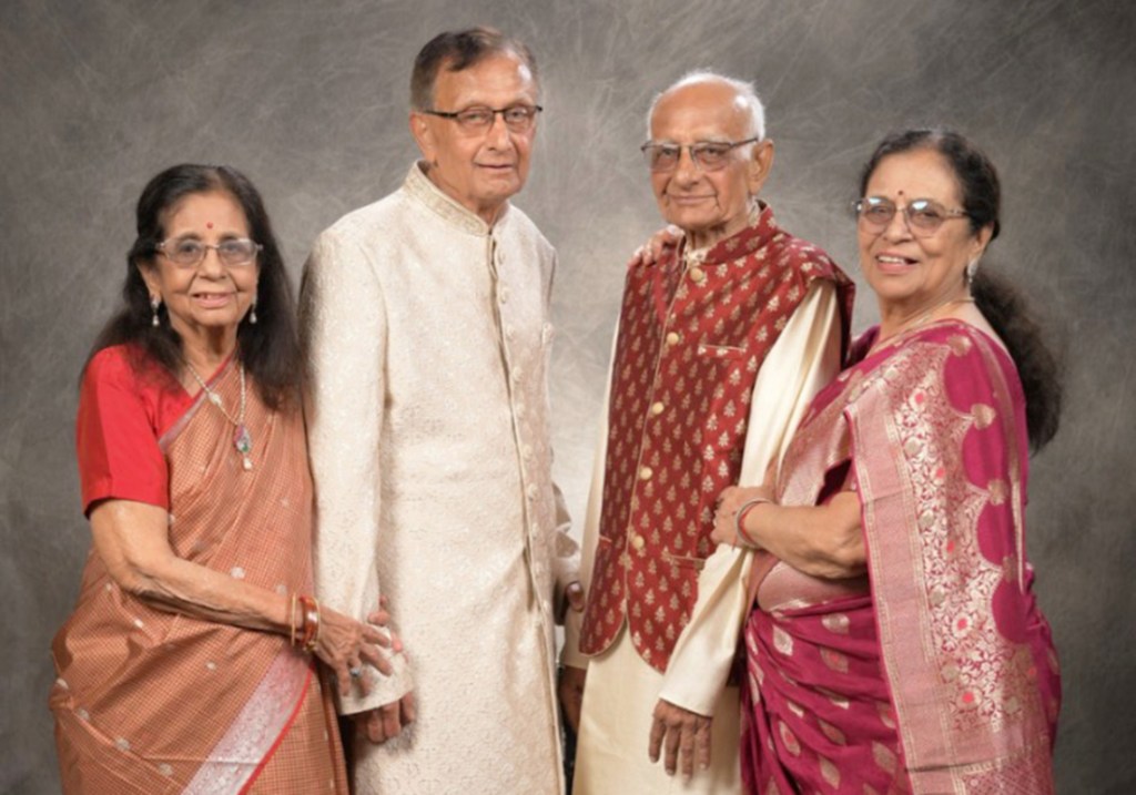 Photo of four people in traditional Indian clothing.
