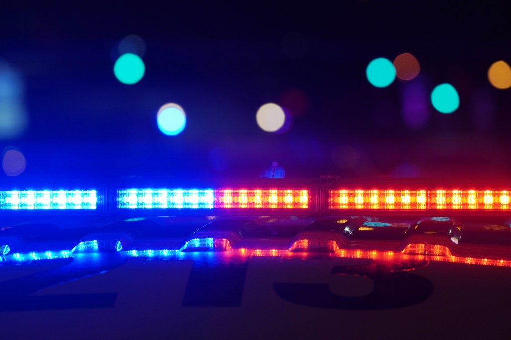 Close-up of police car emergency lights at night.