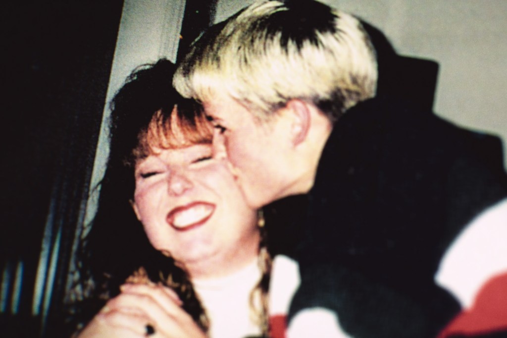 Photo of Amy Bradley being kissed on the cheek.