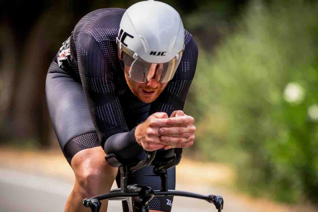 Cyclist in aerodynamic position on a bike.