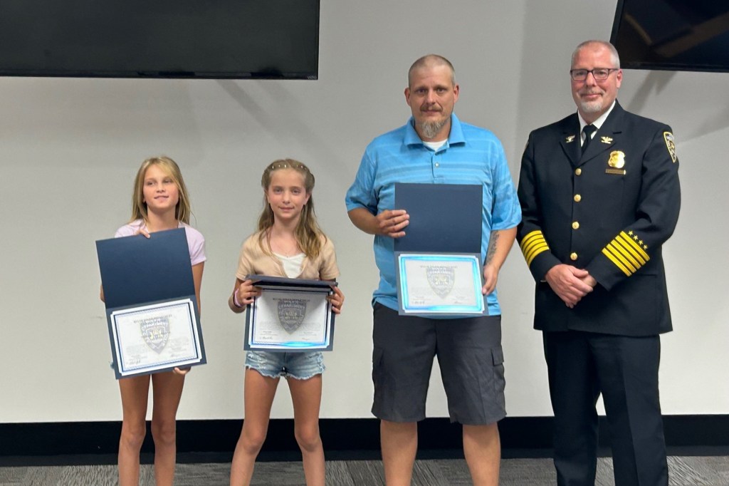 Three children and a man receive Wixom Police Department Civilian Citation Awards.