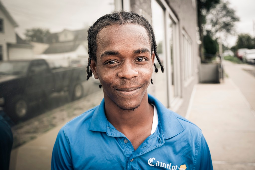 Portrait of a young man in a blue polo shirt.