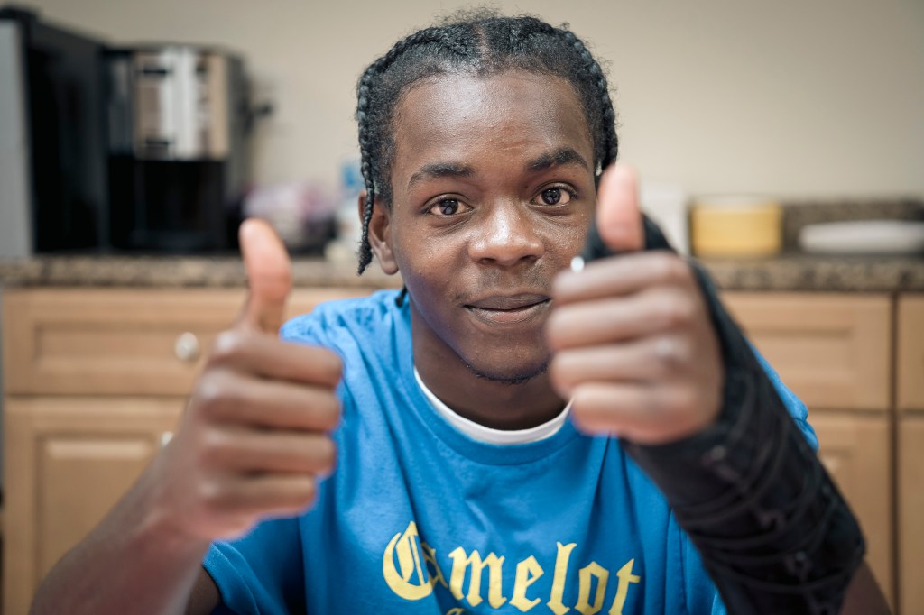 Young man giving two thumbs up.