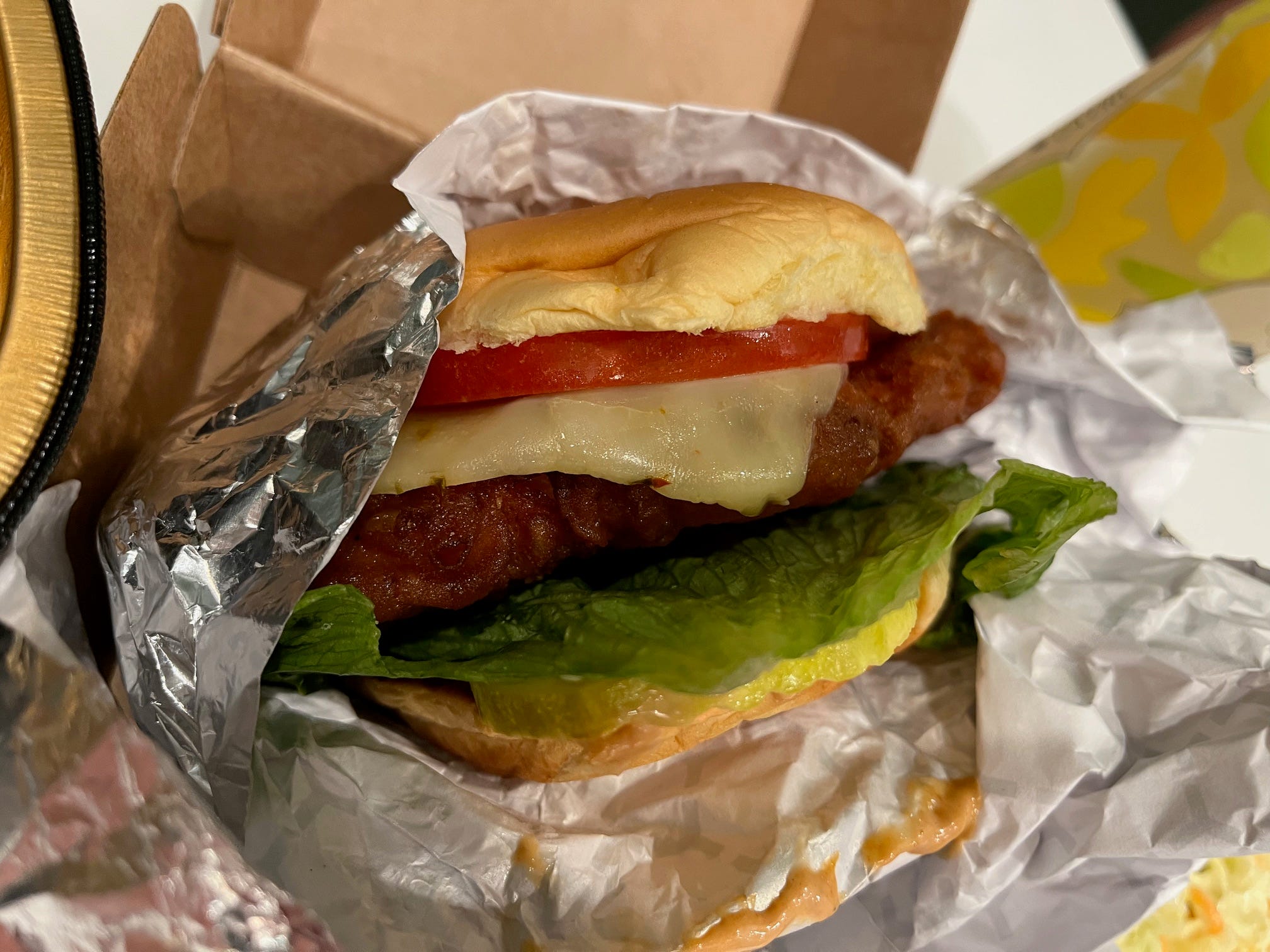 A spicy chicken sandwich from Wonder sits in a foil wrapper