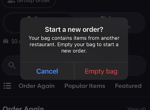 A notification in the Seamless app reads: "Start a new order? Your bag contains items from another restaurant. Empty your bag to start a new order."