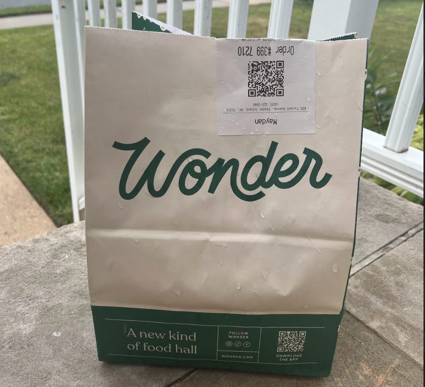A bag of Wonder food sits on a porch