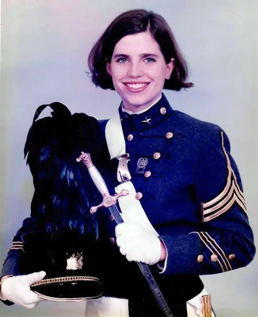 Nancy Mace, the first woman to graduate from The Citadel's Corps of Cadets program, holding a sword and hat.