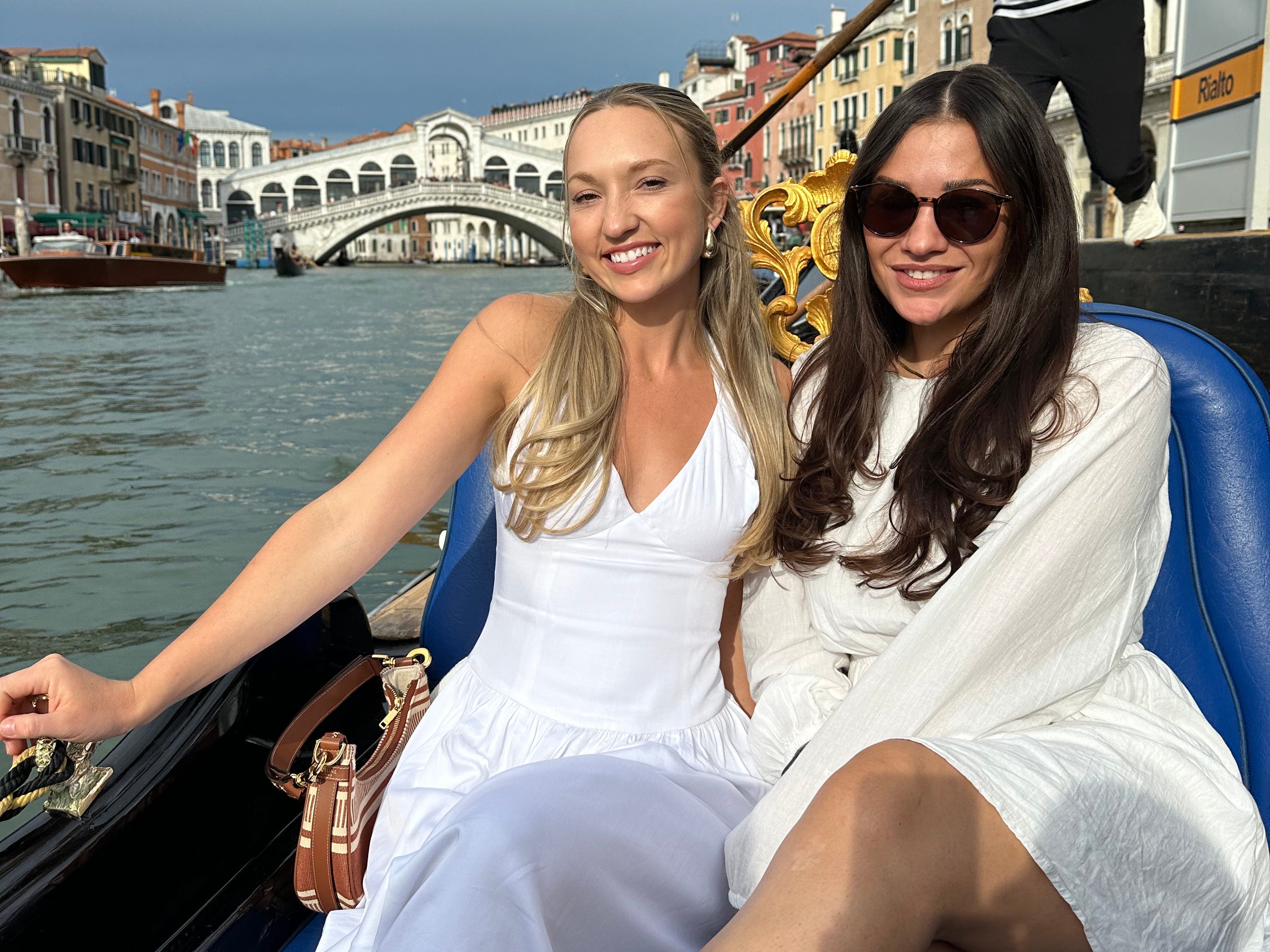 Chloe and her friend smile while on a gondola ride in Venice.