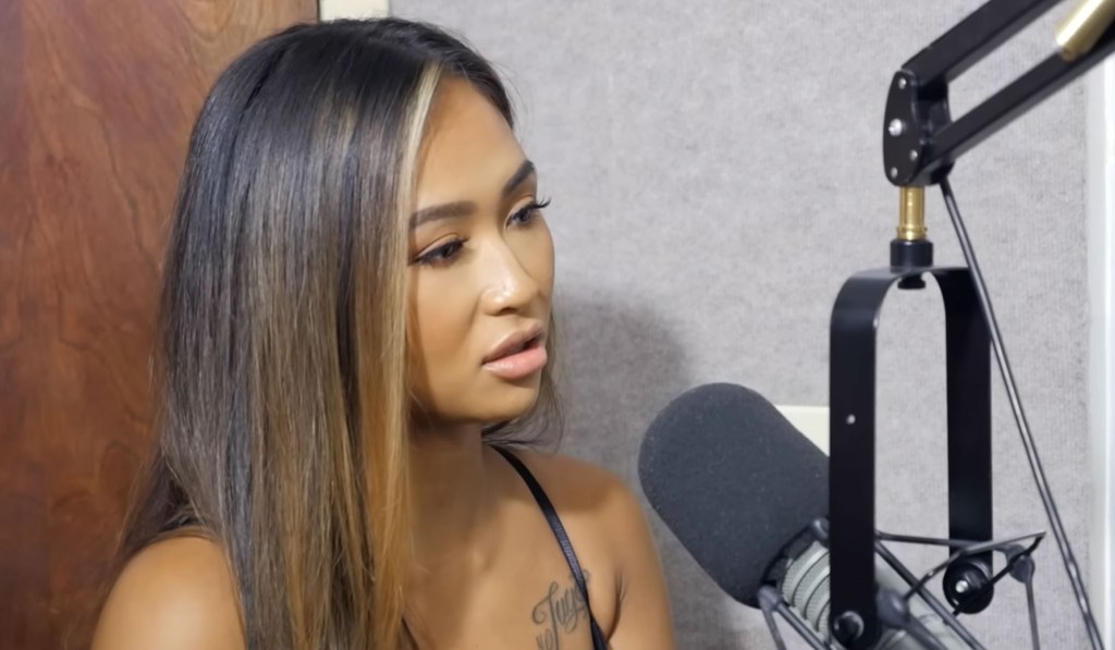 Woman speaking into a microphone.
