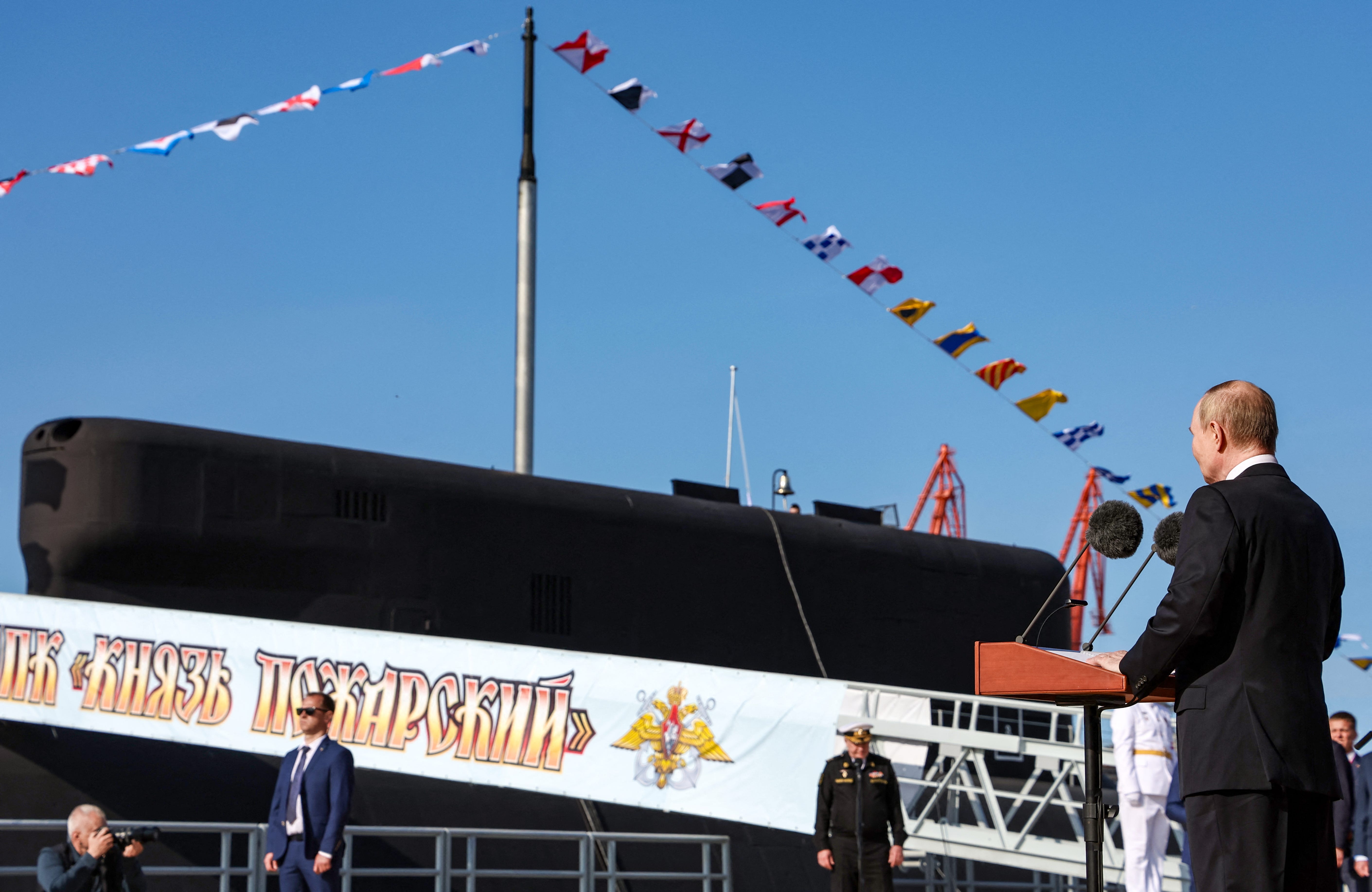 In this pool photograph distributed by the Russian state agency Sputnik, Russia's President Vladimir Putin attends a flag-raising ceremony for the latest Project 955A (Borey-A) strategic nuclear-powered submarine Knyaz Pozharsky in Severodvinsk on July 24, 2025.