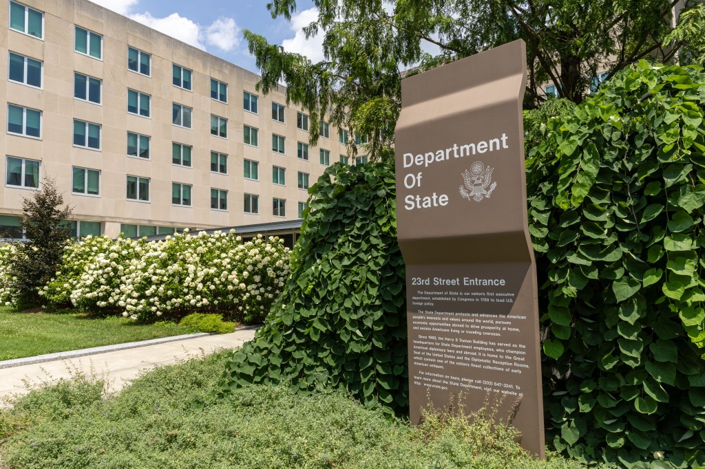 Photo of the U.S. Department of State building in Washington, D.C. with a sign indicating the 23rd Street entrance.