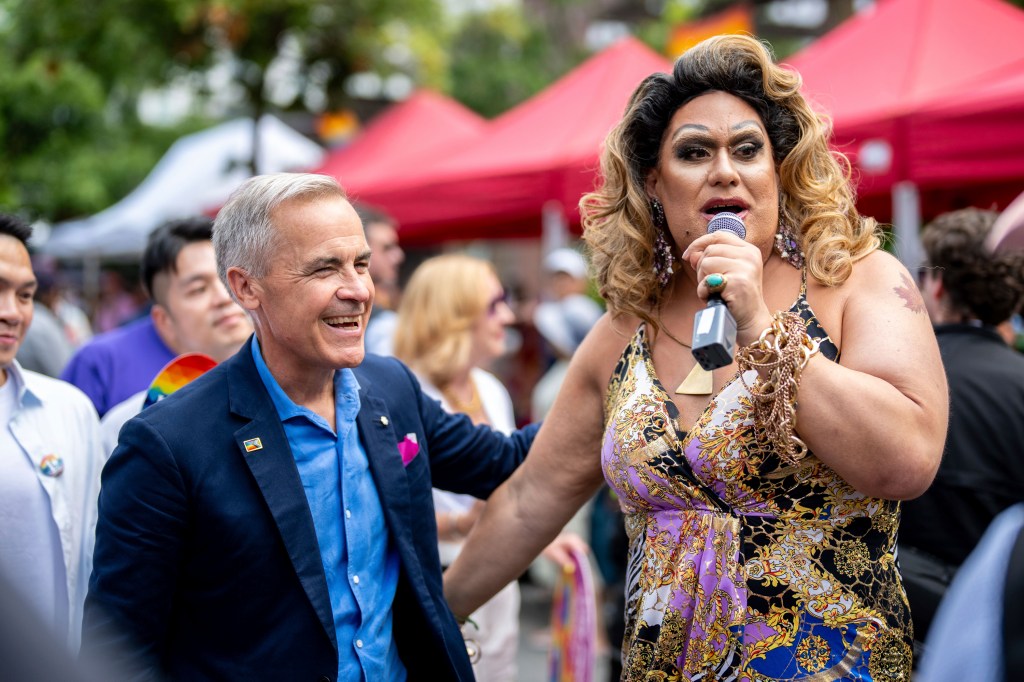 A man and a drag performer at the Vancouver Pride Parade.