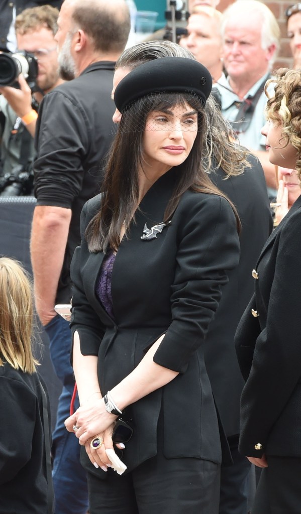Aimee at Ozzy's funeral, wearing a bat brooch