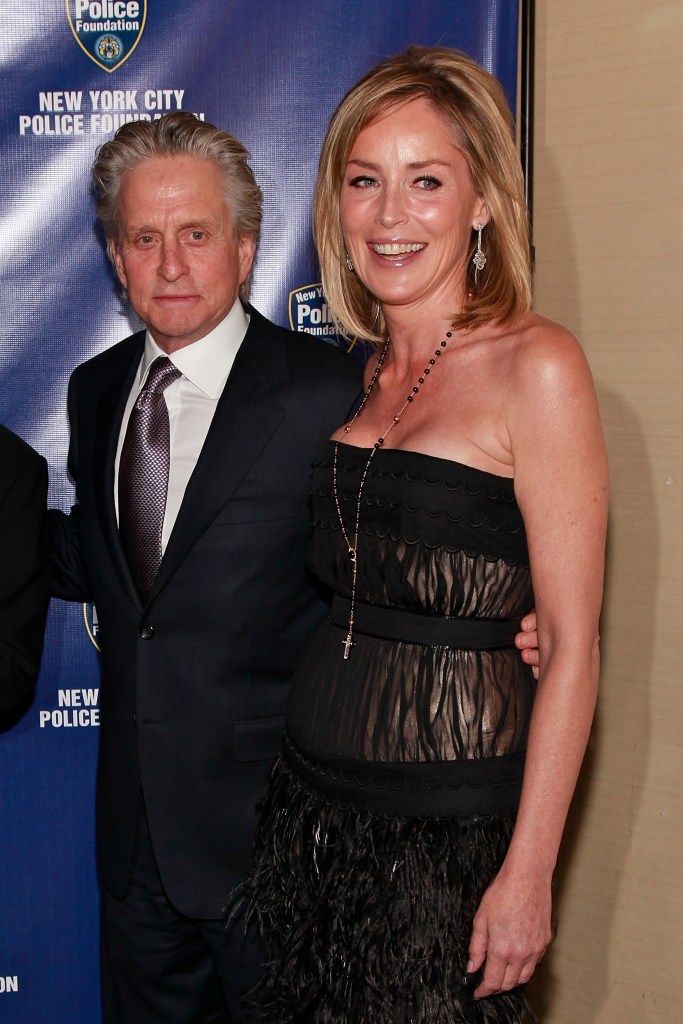 Sharon Stone and Michael Douglas  posing together on the red carpet.