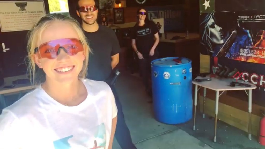 Woman smiling at a shooting range.