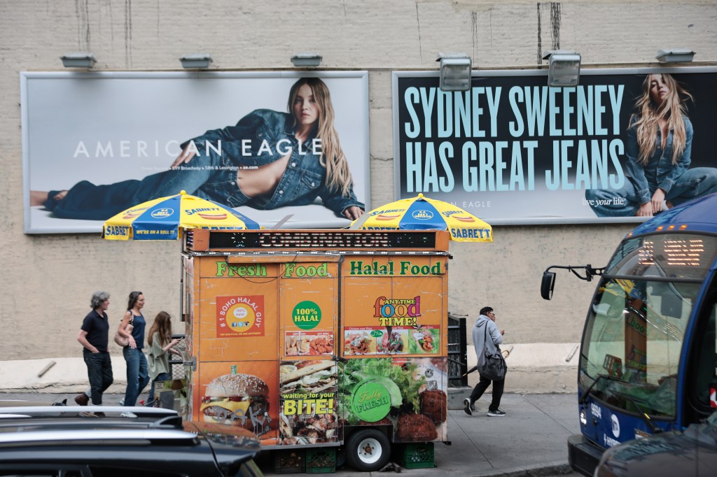 Sydney Sweeney in American Eagle jeans advertisements on a city building, with a halal food cart in the foreground.