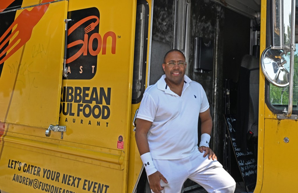 Andrew Walcott, owner of Fusion East Caribbean restaurant, standing by his food truck.
