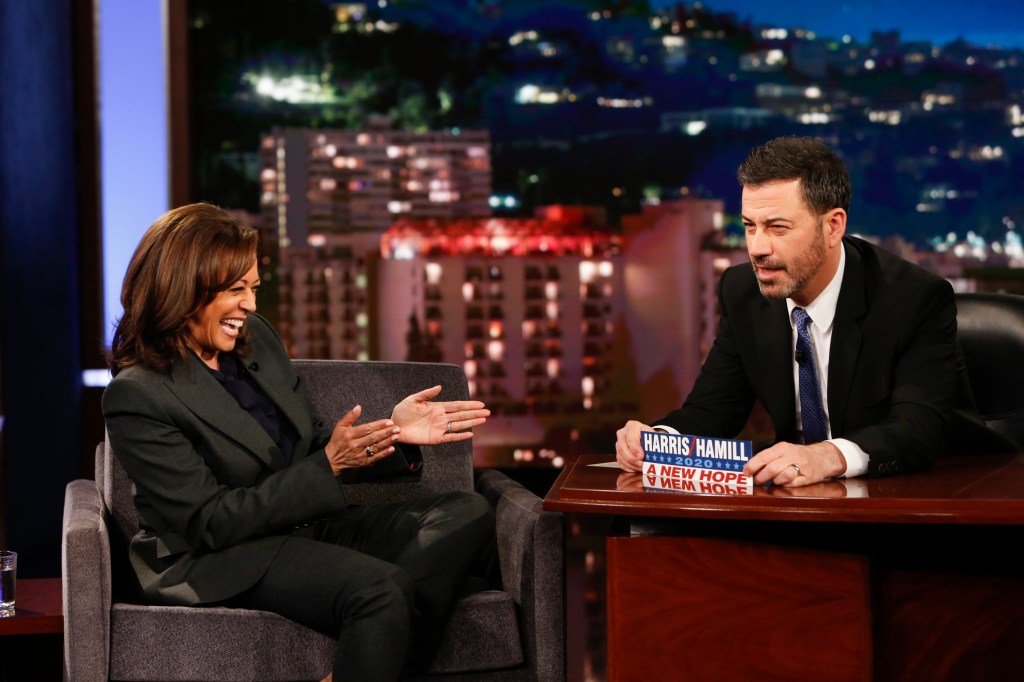 Jimmy Kimmel in a black suit, Kamala Harris in a grey suit and black top.