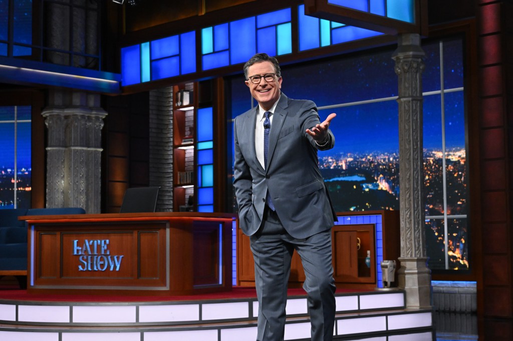 Stephen Colbert in a grey suit, grey shirt and tie.