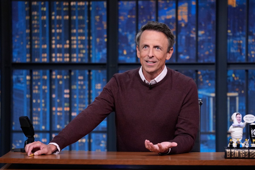 Seth Meyers in a maroon sweater and white shirt.