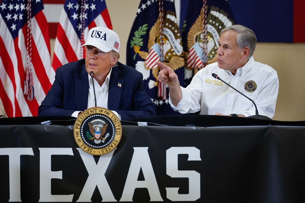 President Donald Trump and Texas Governor Greg Abbott participate in a round table event at the Hill Country Youth Event Center to discuss last week's flash flooding on July 11, 2025 in Kerrville, Texas.
