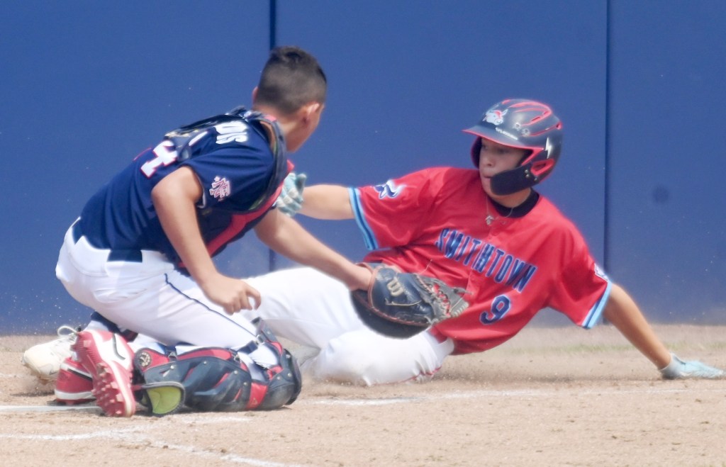 St James Smithtown's Dante Madera (9) manages to slide in safe eluding the tag by Fairfield catcher Jimmy Taxiltaridis (24) during a three run 5th inning for NY.