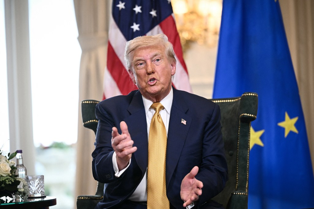 President Trump speaking with the US and EU flags in the background.