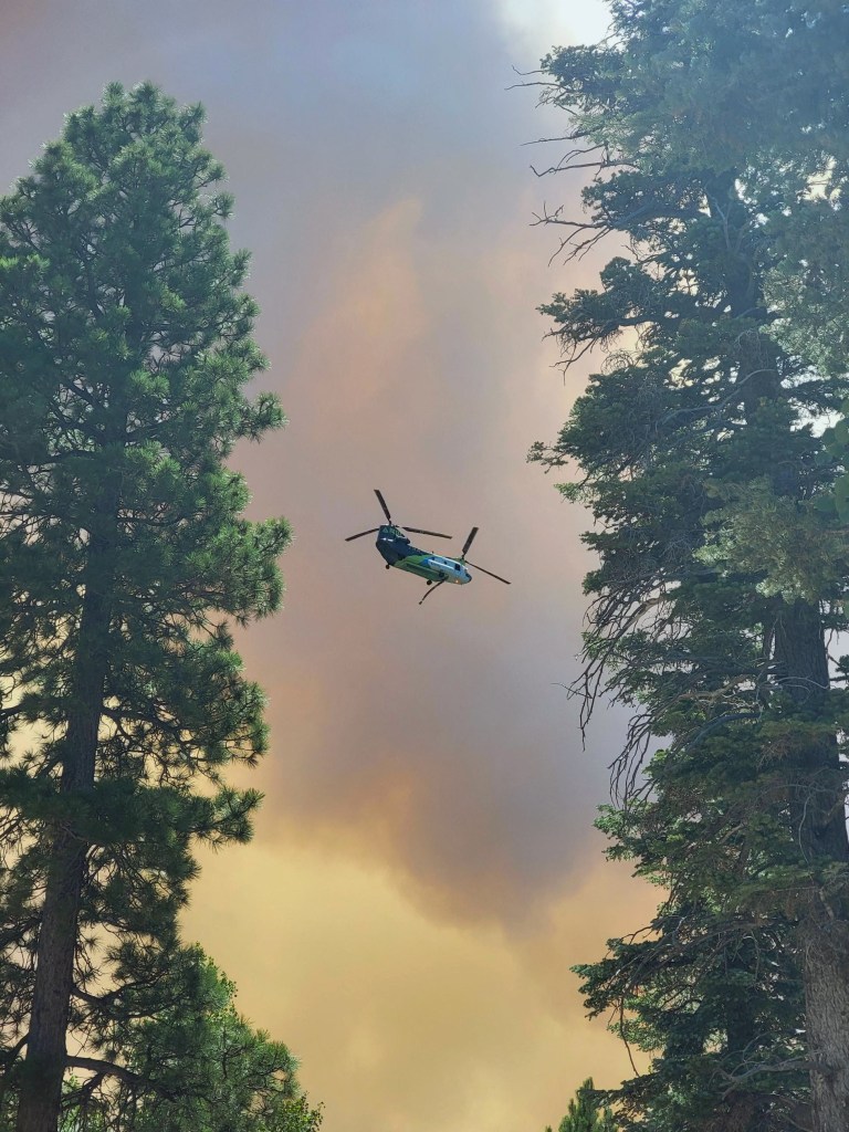 This handout photo provided by the Southwest Area Incident Managemment Team shows a helicopter fighting the Dragon Bravo fire on the North Rim.
