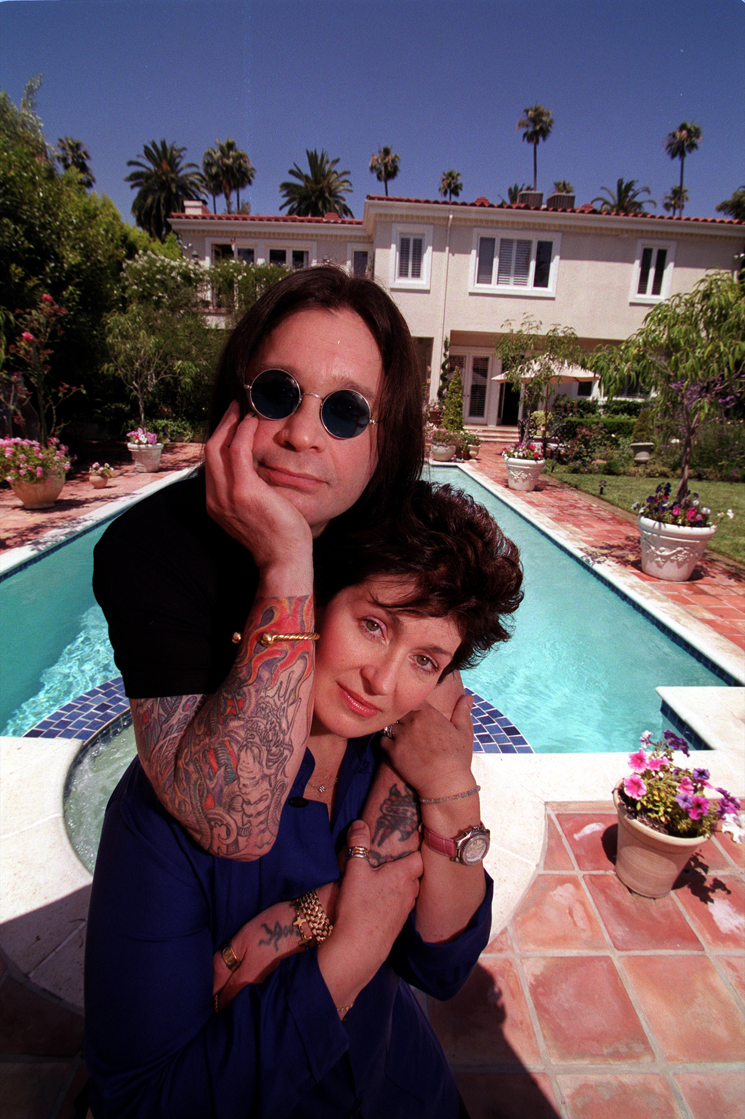 Sharon and Ozzy Osbourne by a pool. 