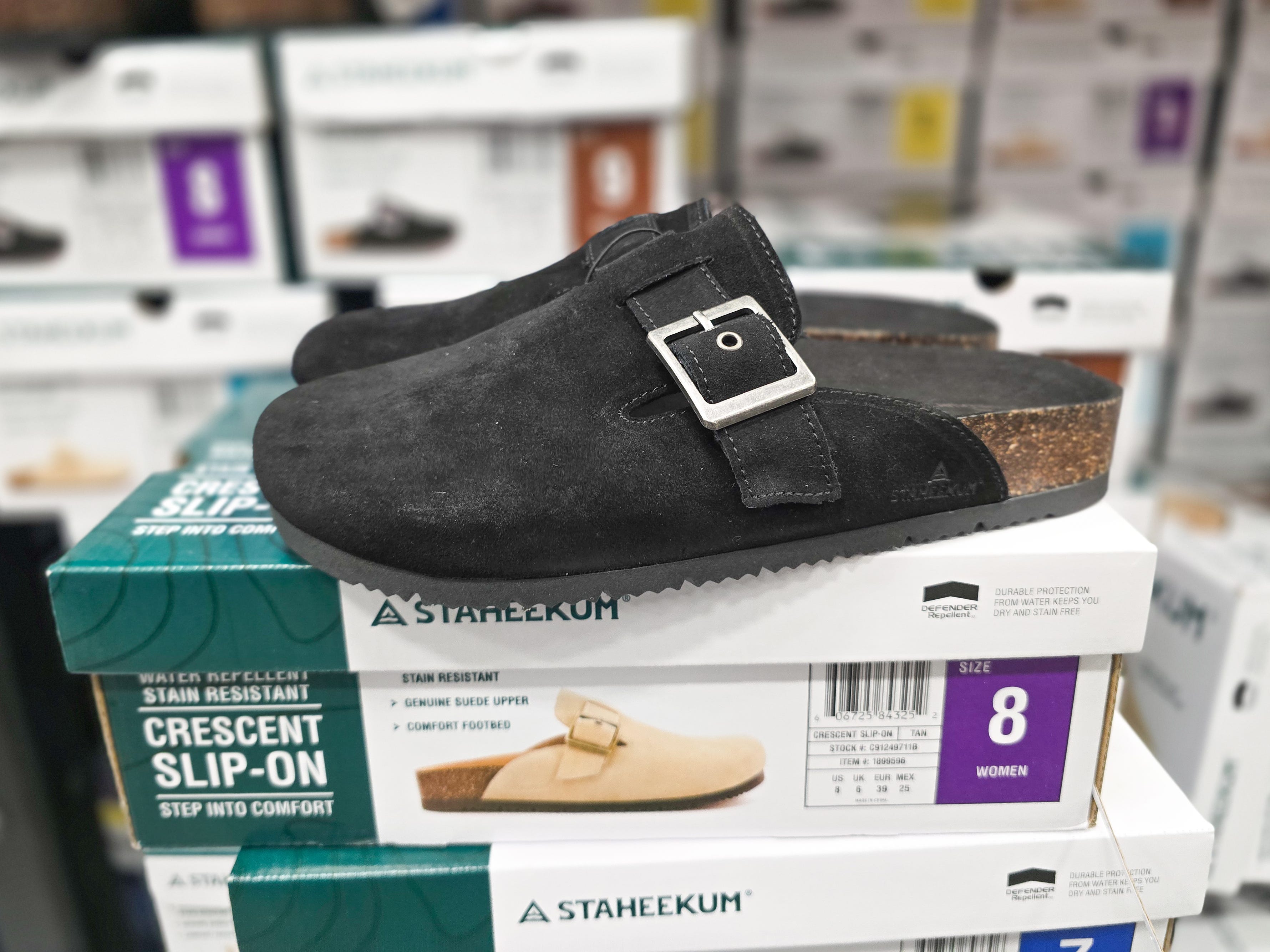 A pair of black backless clogs on display at Costco.